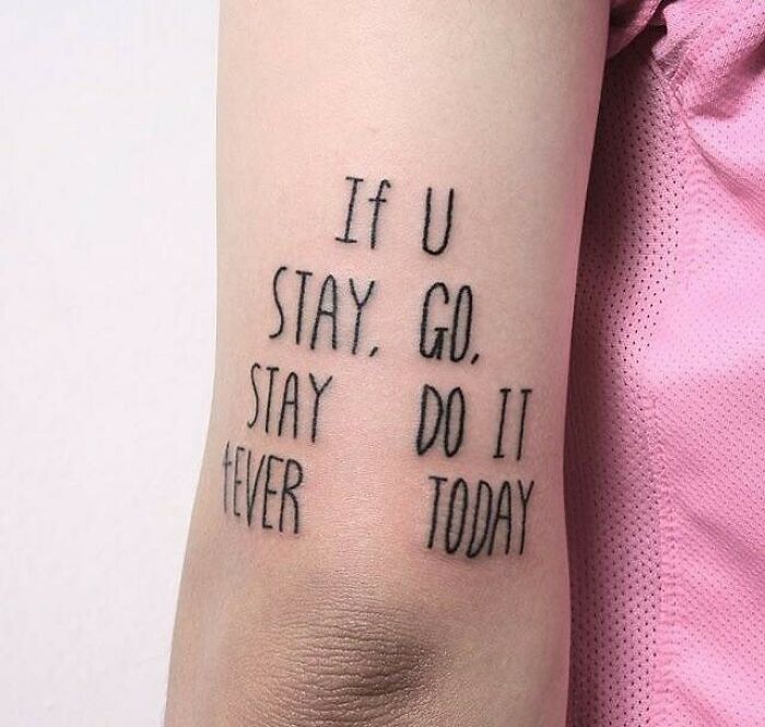 Tattoo with mismatched words on an arm, highlighting a permanent mistake in ink.