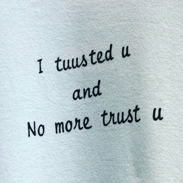 T-shirt with text: "I tuusted u and No more trust u," humorously lost in translation.