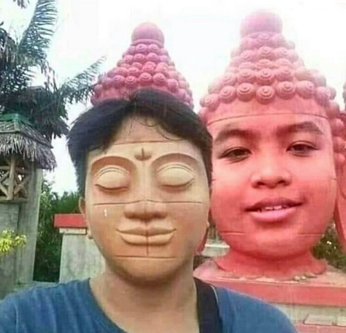 Person aligned with a statue creating a cursed image illusion.