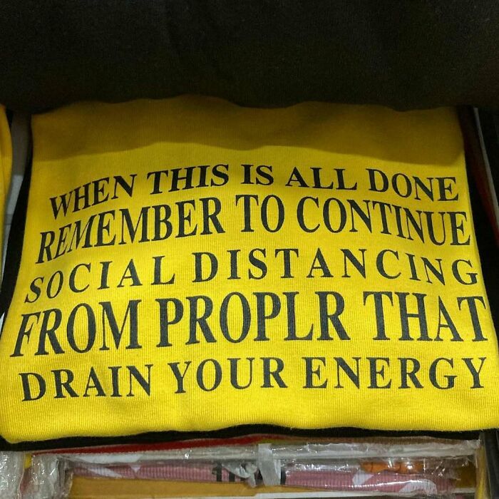 Yellow t-shirt with humorous mistranslation about social distancing.