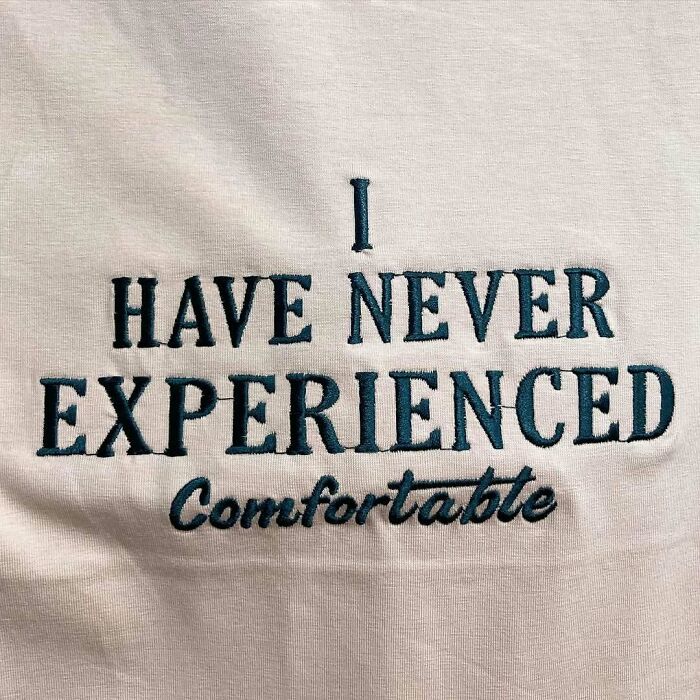 T-shirt with text: "I have never experienced comfortable," showcasing translation humor.