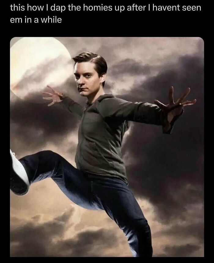 Man humorously posing in front of a dramatic sky background, mimicking an action scene.