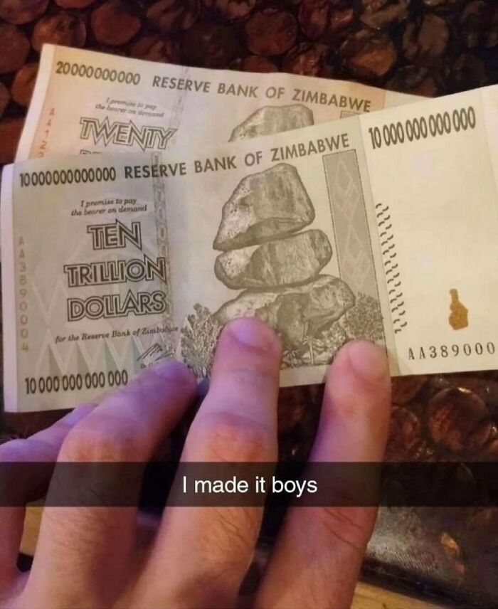 Hand holding Zimbabwe banknotes with humorous caption, representing a random cursed image.