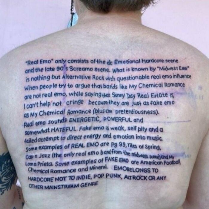 Tattooed text paragraph covering a person's back, featuring a permanent ink mistake.