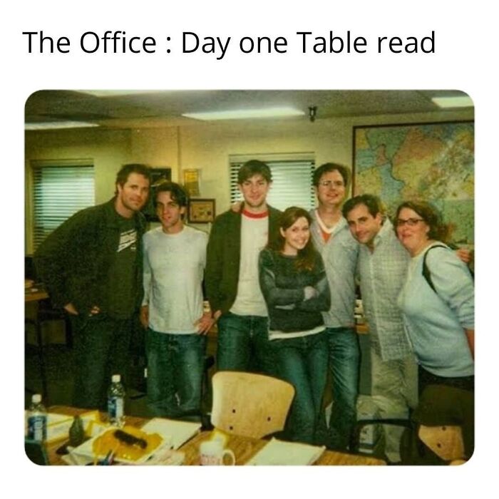Cast of 'The Office' during a table read, gathered in a casual office setting.