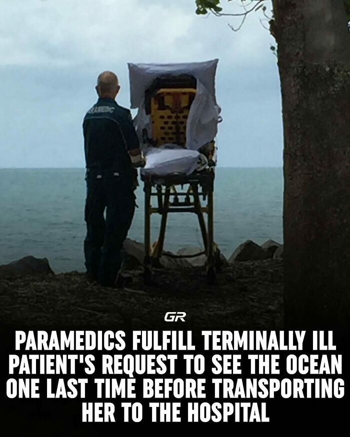 Paramedic with stretcher overlooking the ocean, fulfilling terminal patient's wish.
