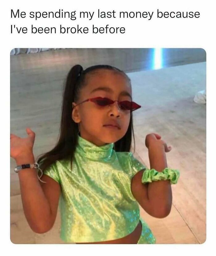 Child in green outfit and red sunglasses shrugging, illustrating a relatable meme moment.