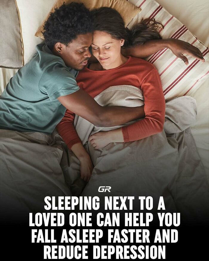 Couple sleeping in bed, highlighting interesting facts about health benefits of sleeping next to a loved one.