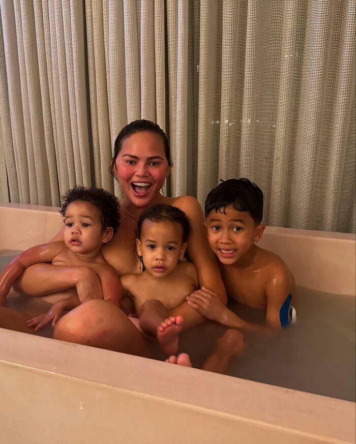 Celebrity encounters relaxing together in a bathtub showing joyful and candid family moments with children.