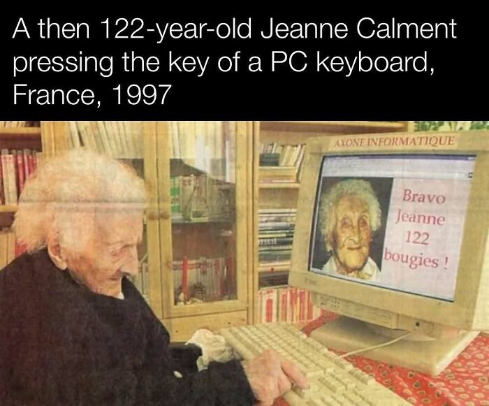Elderly woman using a computer keyboard in 1997, an interesting history post illustrating age and technology.