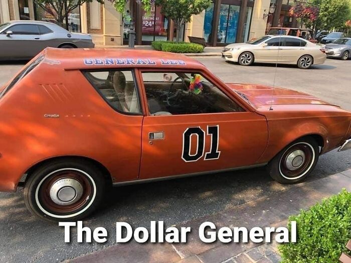 Orange car with "01" and "General Lee" lettering, dubbed "The Dollar General," parked on a street. Car memes humor.