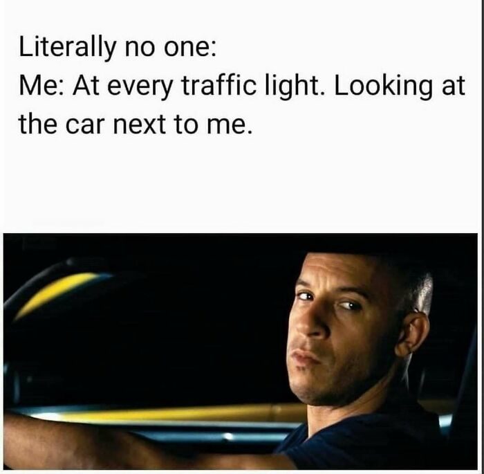 Driver at traffic light humorously staring at the car next to him, showcasing a relatable car meme.