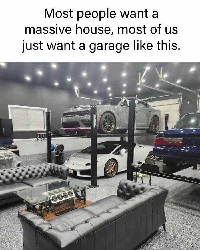 Luxury garage with cars on lifts, stylish couches, and engine block coffee table; a car meme highlighting dream garages.