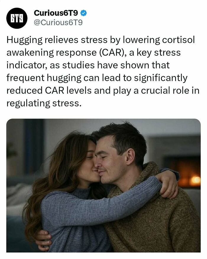 A couple hugging closely on a sofa, showcasing the calming effect of physical closeness on stress.