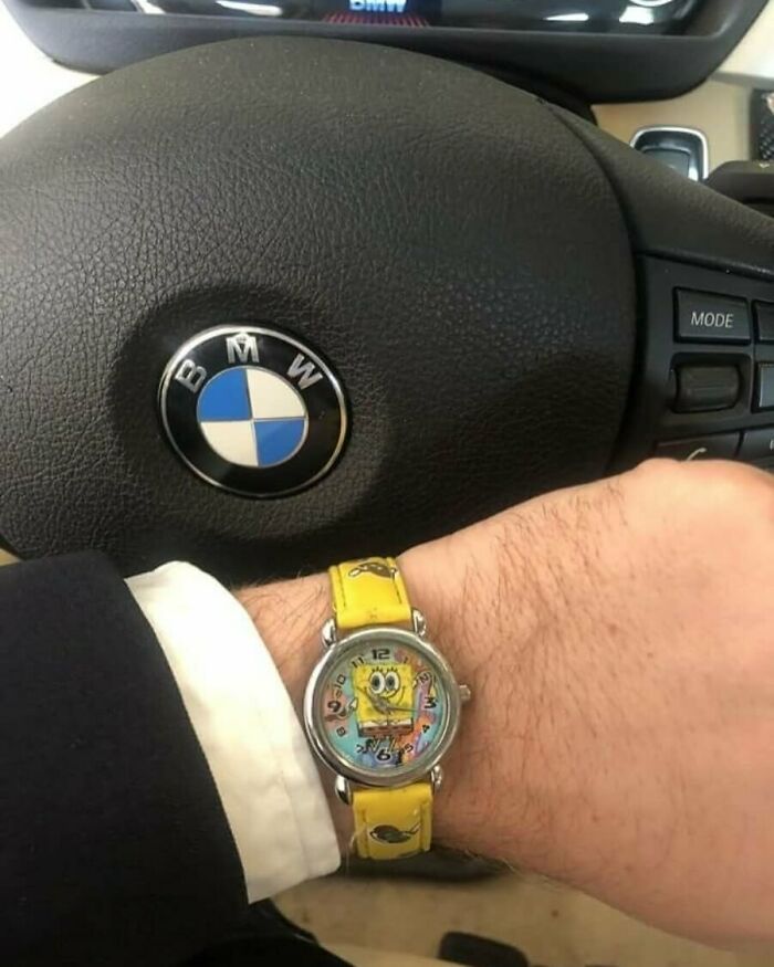 SpongeBob watch on a man's wrist with a BMW steering wheel in the background, representing the hardest posts theme.
