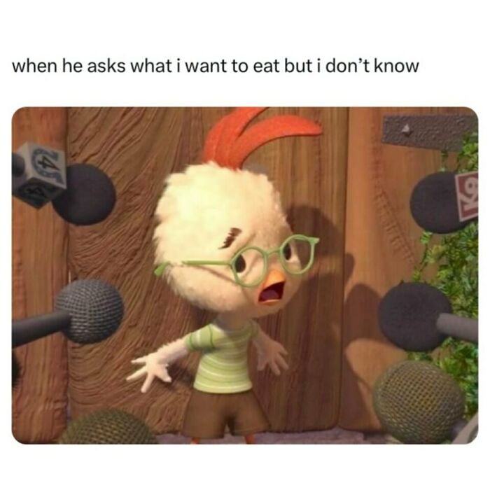 Animated chicken character surrounded by microphones, expressing confusion; a funny meme to share with friends.