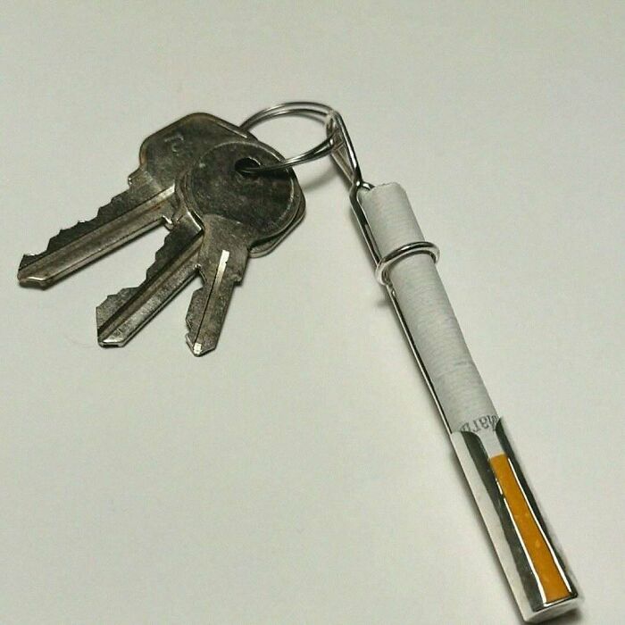 Two metal keys on a keyring with a cigarette-shaped charm, from a humorous IG post.