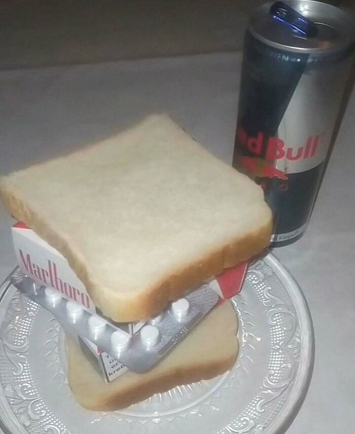 A humorous arrangement of bread, medication, and cigarettes, with an energy drink beside it, showcasing an ironic post.