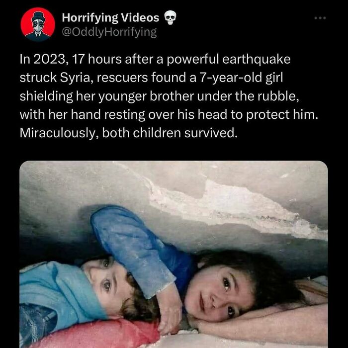 Two children lie under rubble after earthquake. A girl shields her brother, hand over his head. A touching, unnerving image.