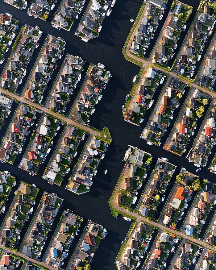 Aerial images of residential area with waterways and boats, showcasing the world from a whole new perspective.