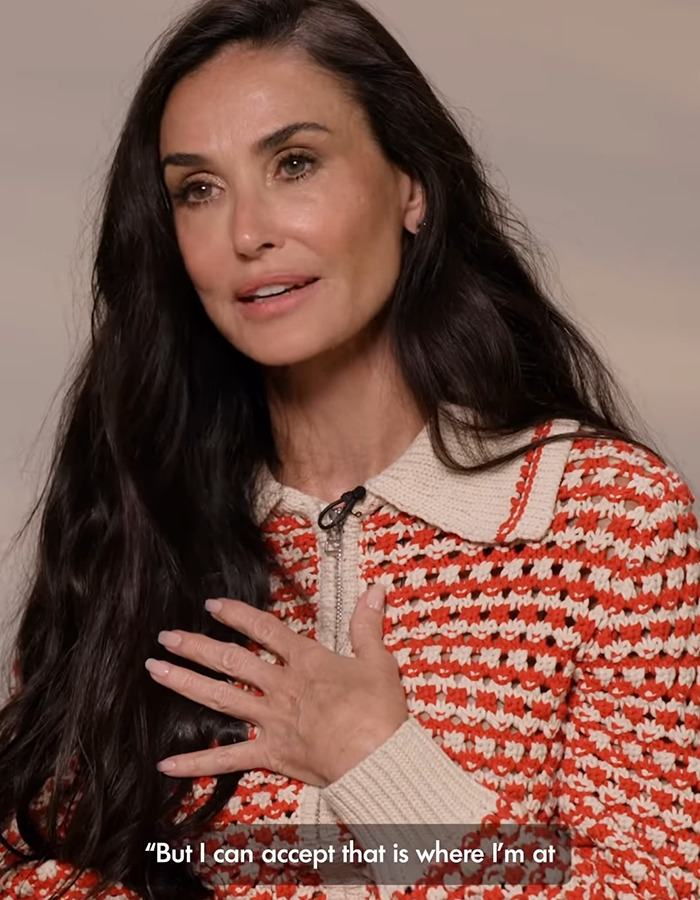 Woman in a patterned sweater speaks passionately, symbolizing natural beauty over plastic. Woman in a patterned sweater speaks passionately, symbolizing natural beauty over plastic.