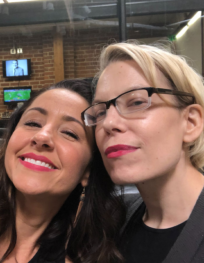 Two smiling women in a cozy indoor setting, related to a story about personal transformation after cancer diagnosis.