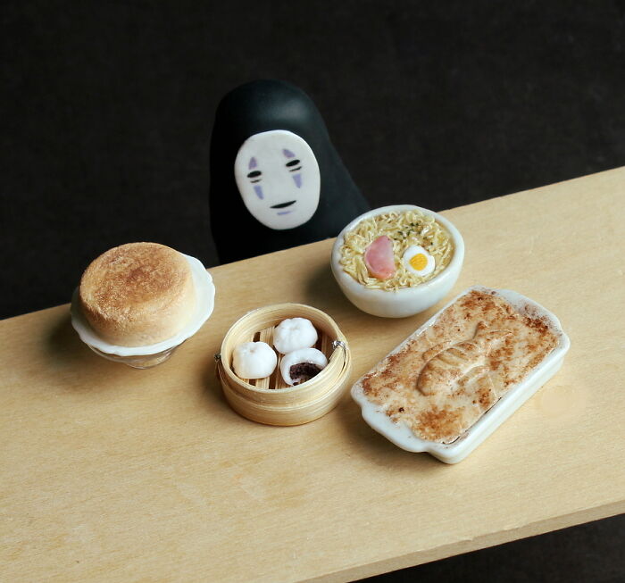 Miniatures of food dishes with a small figure, showcasing intricate details in a secret world setting.
