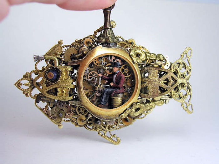 Intricate steampunk miniature featuring a tiny figure inside ornate gears and cogs.