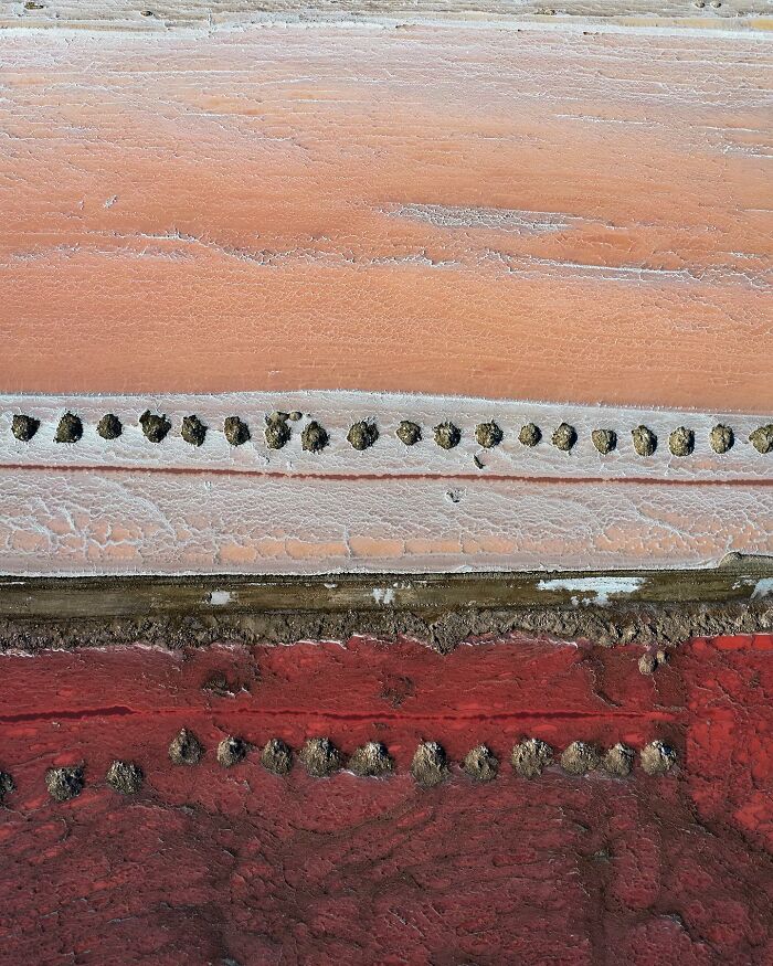 Aerial view from Dimitar Karanikolov's drone showing abstract patterns in red and orange tones.