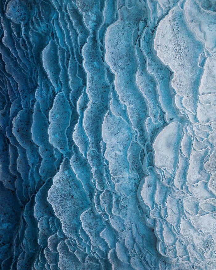 Aerial view of textured blue formations captured by Dimitar Karanikolov’s drone photography.