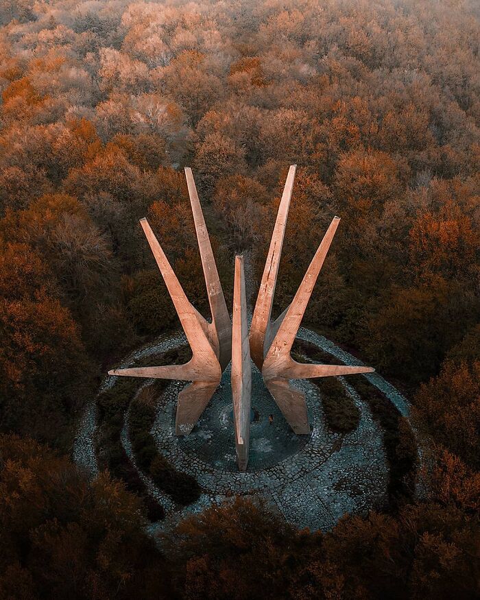 Aerial view of a striking, star-shaped monument in a forest, captured by drone photographer Dimitar Karanikolov.