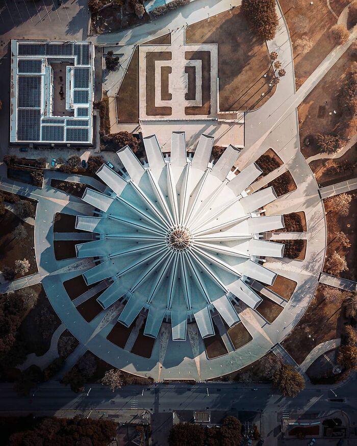 Aerial view of a modern circular building, showcasing captivating drone photography by Dimitar Karanikolov.