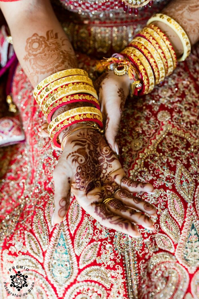 Bride's hands with intricate henna and colorful bangles at Premios FDB Awards wedding photo.