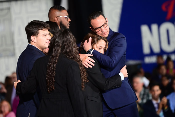 Group embraces with concern, likely related to Pennsylvania Governor's Mansion arson investigation. Group embraces with concern, likely related to Pennsylvania Governor's Mansion arson investigation.