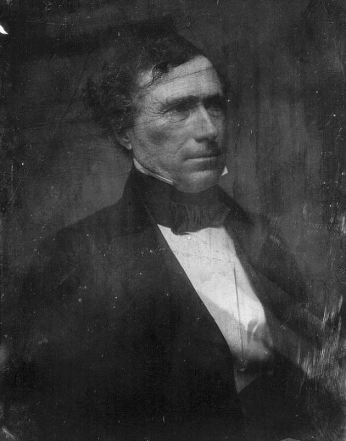 Black and white portrait of a famous historical figure wearing formal 19th-century attire in a rare photo.