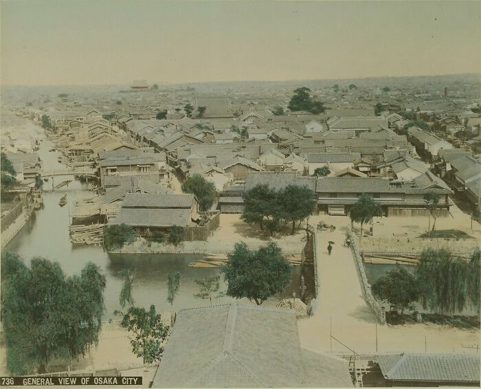 Aerial view of Osaka city in the 1800s showing traditional buildings and waterways in historic Japan.