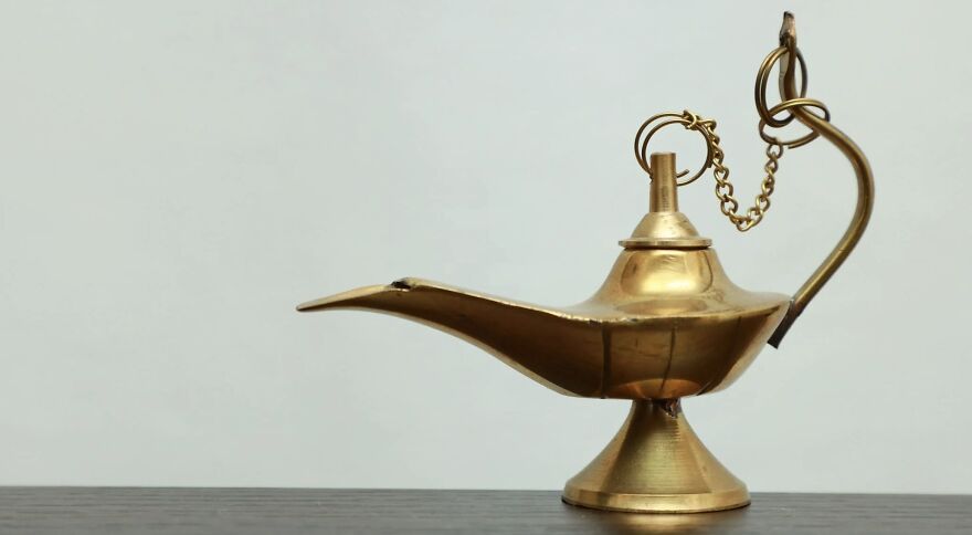 A golden oil lamp on a table, symbolizing ethical dilemmas in decision-making.