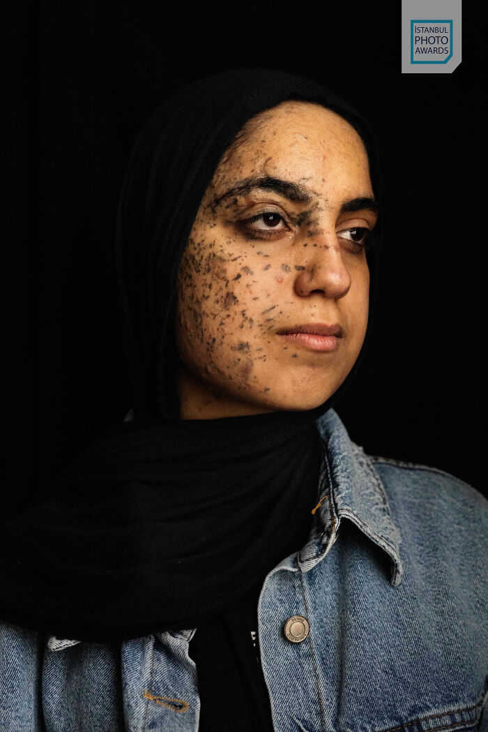 Female portrait in denim jacket with headscarf, capturing strength. Istanbul Photo Awards 2025 image.