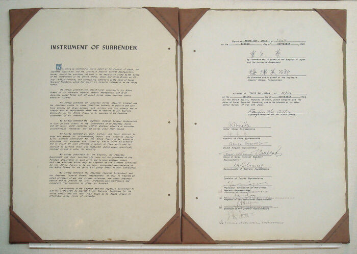 "Historic artifact document featuring the Instrument of Surrender with signatures from a significant historical event."