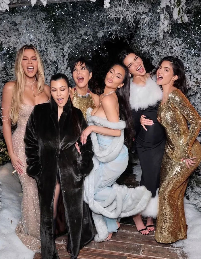 Group of women in glamorous outfits posing at a winter-themed event. Group of women in glamorous outfits posing at a winter-themed event.