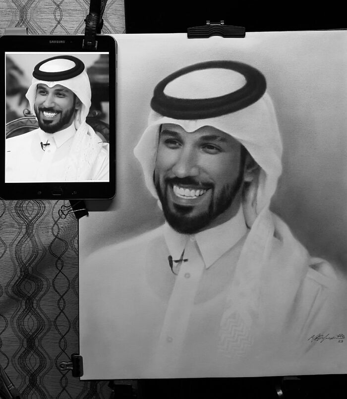 Hyper-realistic pencil portrait of a smiling man in traditional attire, with tablet reference on the side.