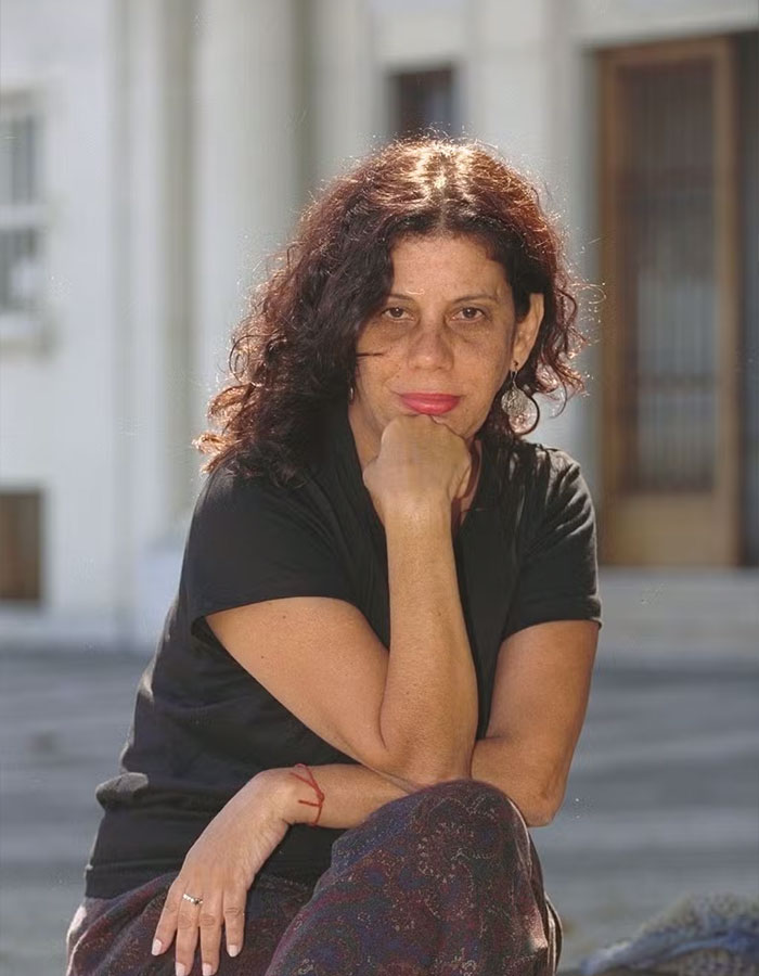 Grandmother of Hollywood actress, seated outdoors, wearing a black shirt, looking thoughtfully at the camera.