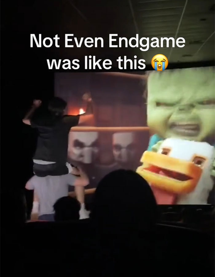 A person stands on someone's shoulders in a theater during a Minecraft movie, causing an "annoying" experience.
