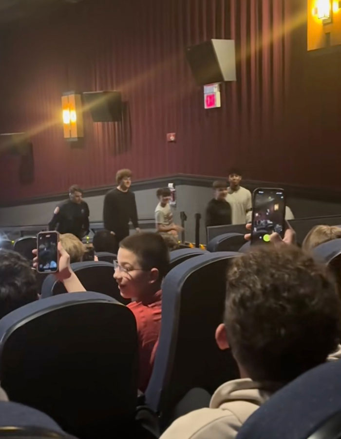 Cinema audience filming Minecraft movie event with phones, highlighting a trend that viewers find disruptive to the experience.