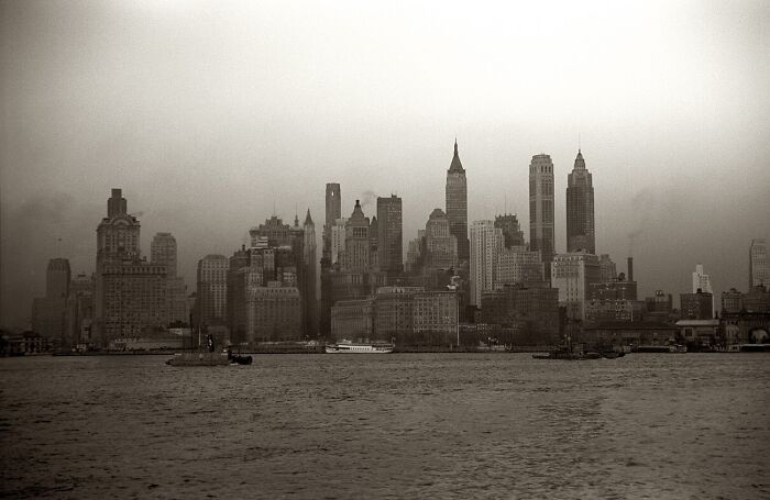 Historic skyline of New York City shrouded in fog, reflecting eerie coincidences from history.