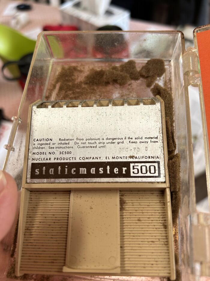 Staticmaster 500 device with caution label about dangerous polonium radiation, highlighting potential danger.