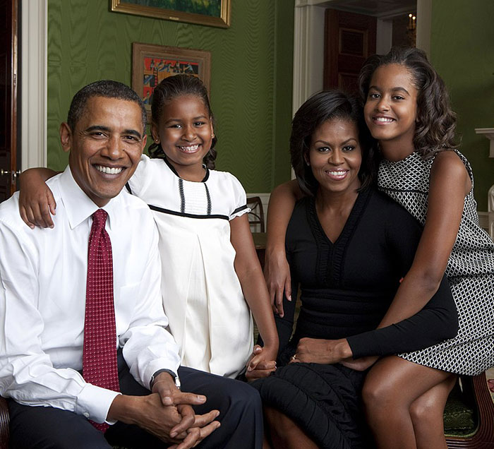 Smiling Barack Obama with family in a warm, elegant setting, highlighting marriage harmony.