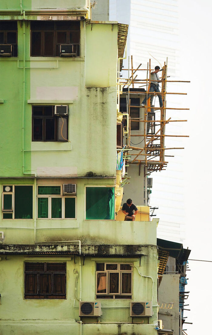 Parallel Repairs, 2024 - Two Men Working On Repairs At Different Floors Of An Old Building
