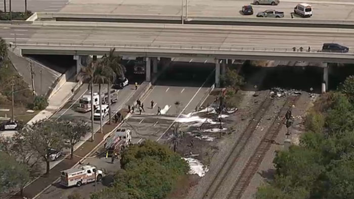 Aerial view of a crash site in Florida with emergency responders at the scene.