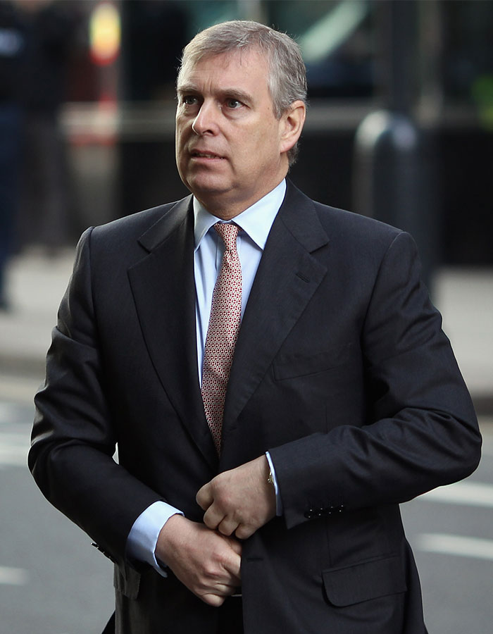 A man in a suit walking outdoors, capturing a serious moment.